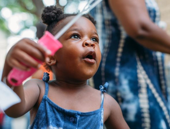 girl blowing bubbles